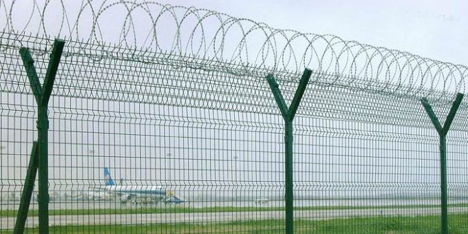 Razor wire is installed on the security fence on the airport.