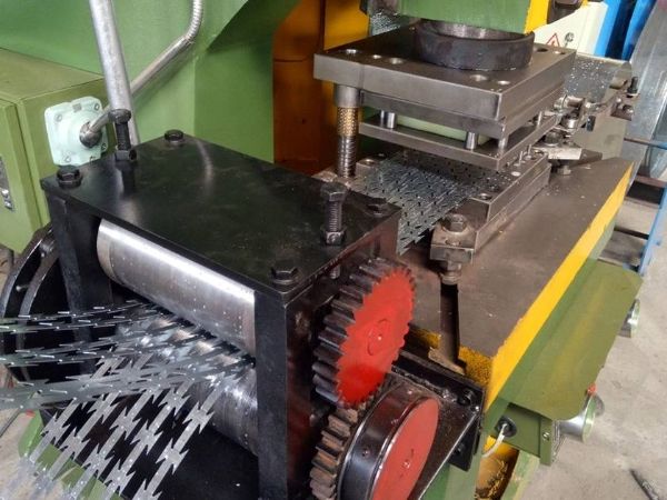 The punch press is punching steel sheet into razor blades.