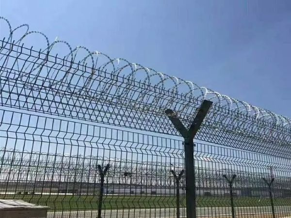 Cross razor wires are installed at the top of security fence.