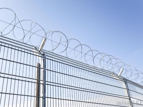 Cross razor wires are installed at the top of double wire fence.