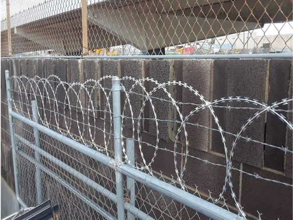 Flat wrap razor wire is installed on the chain link fence gate.