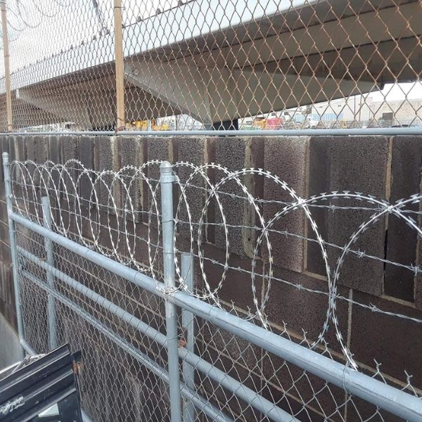 Flat wrap razor wire is installed on the top o chain link fence.