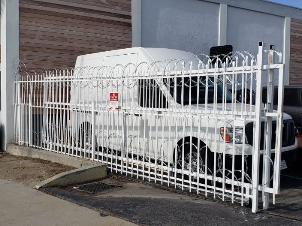 Flat wrap razor wire is installed at the top and bottom of sliding door.