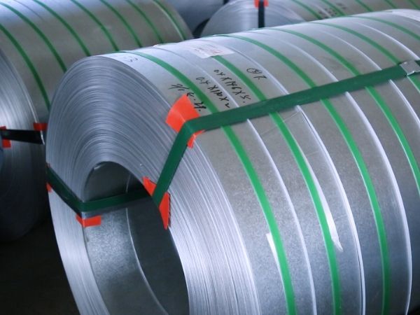 Galvanized steel sheet coils are neatly placed on the ground.