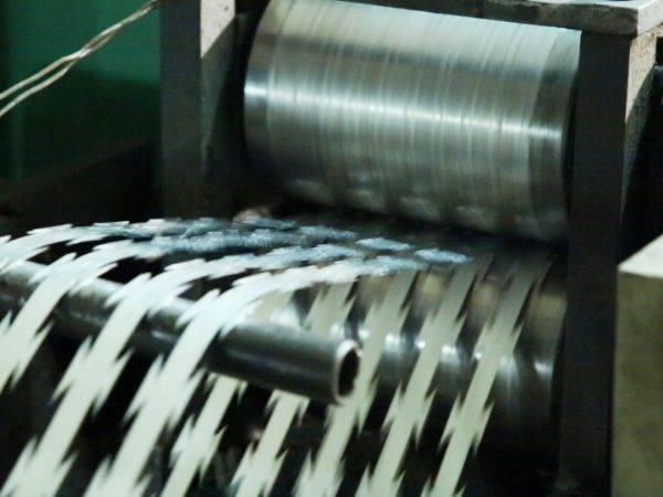 The punch press is punching the steel sheet into razor blades.